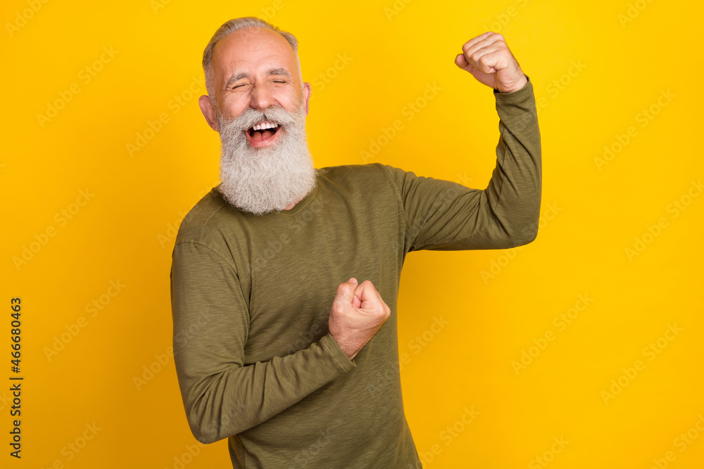 Sticker Photo of hooray old white beard man hands fists wear green sweater isolated on yellow color background