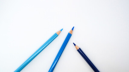 Stack of colorful pencils on white desk table, with copy space