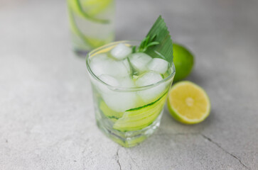 cocktail drink alcoholic with green cucumber and tonic with lime