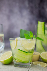 cocktail drink alcoholic with green cucumber and tonic with lime