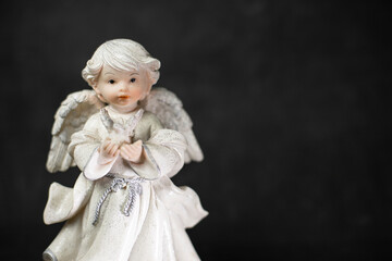 angel figurine on a black background