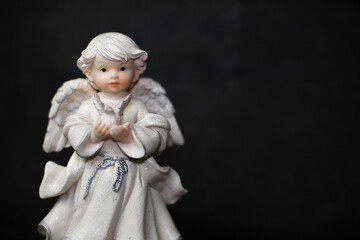 Fototapeta premium angel figurine on a black background