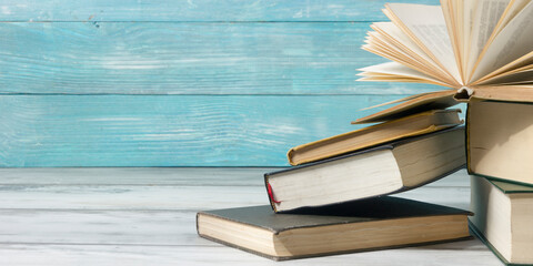 Open book, hardback books on wooden table. Back to school. Copy space