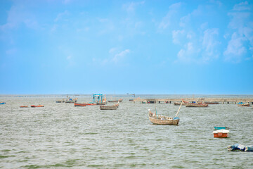 An image composition of landscape empty boats on the ocean fishing in vacation travel day.