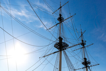 Rigging of a sailing ship against the blue sky.