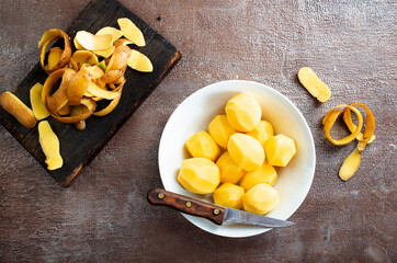 Peeled potatoes for cooking, raw potato on a table