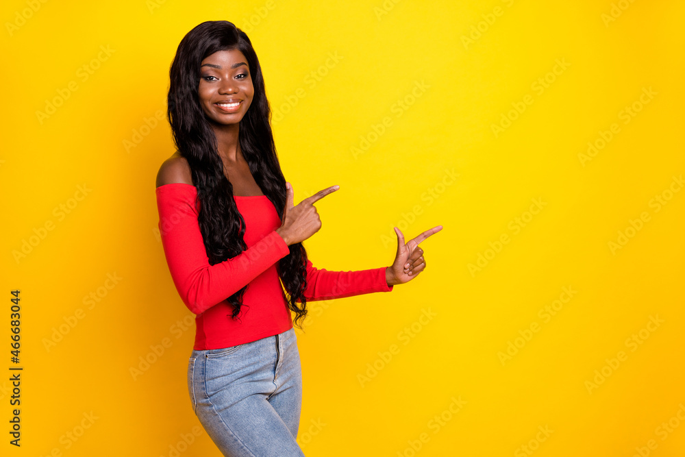 Sticker Photo of cute adorable dark skin lady wear off-shoulders top pointing fingers empty space isolated yellow color background