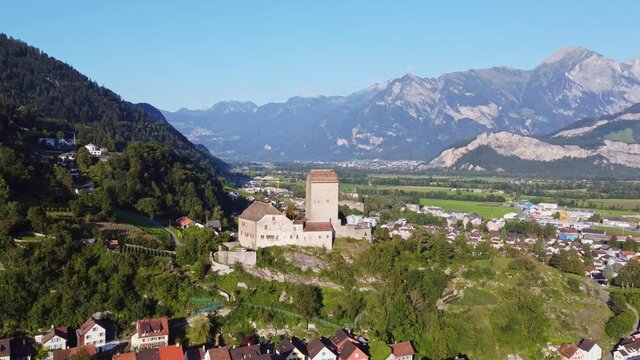 Aerial drone footage of the Sargans village and medieval hilltop fortress in Canton Sankt Gallen in eastern Switzerland. Shot with a forward and tilt down motion. 