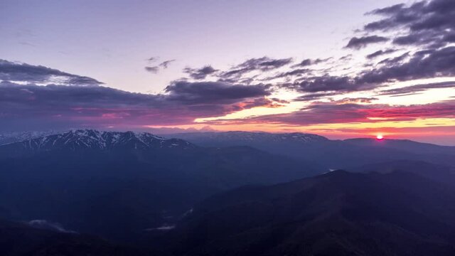 Timelapse of sunset over Fagaras mountains national park from Piatra Craiului national park in Romania