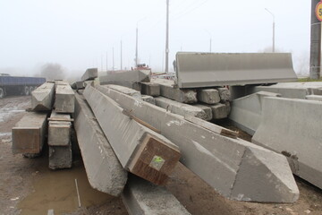 a pile of concrete pillars lying on the ground