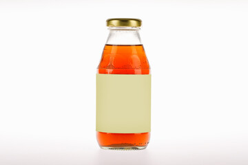 Energizing and invigorating drink product in beautiful transparent glass bottle with blank label of brand advertising for health refreshment and therapy