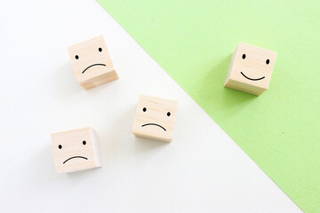 Concept image of satisfaction level. wooden cubes with emotions