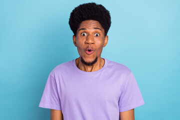 Photo of impressed pretty dark skin guy dressed purple t-shirt big eyes isolated blue color background