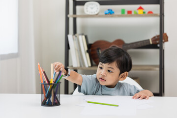 Asian little boy education from home. Developing children's learning before entering kindergarten Practice the skills of drawing and painting.