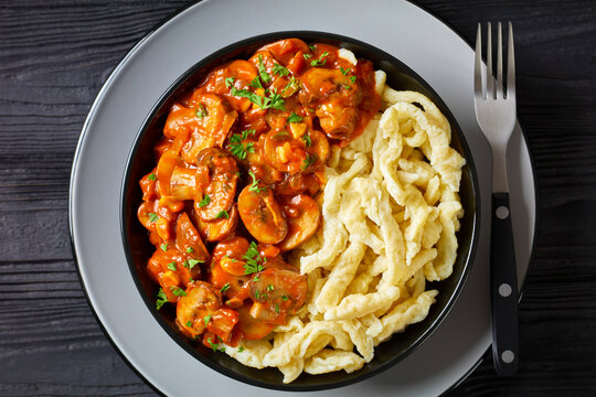 spaetzle with mushroom gravy in a black bowl