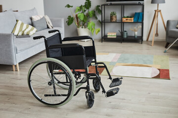 Fototapeta na wymiar Full length background image of empty wheelchair in home interior, copy space