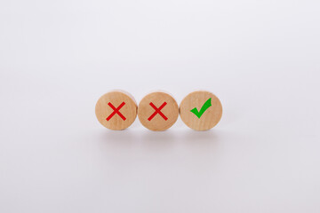 Check mark and x sign symbol on wooden blocks on light  background