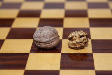 Two walnuts lie on chessboard