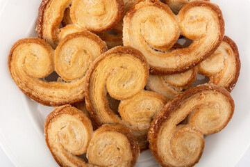 Palmier puff pastry in plate. Top view. Close up