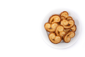 Palmier puff pastry in plate isolated on white background. Top view. Copy space