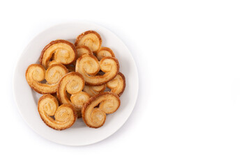 Palmier puff pastry in plate isolated on white background. Top view. Copy space