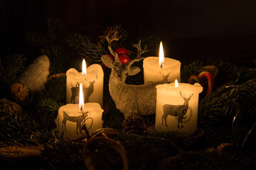 all four Advent candles are lit with deer in the middle