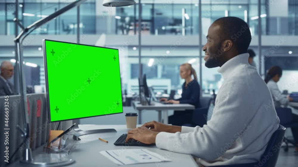 Poster Diverse Modern Office: Handsome Black Businessman Using Desktop Computer with Green Screen Mock Up Display. Manager Working on e-Commerce App Development, Project Marketing, Big Data Analysis