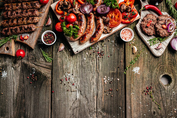 Grilled meat and vegetables on wooden table. Barbecue menu. banner, menu, recipe place for text,...