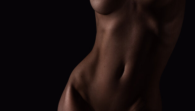 Beautiful lines of the female body on a dark background
