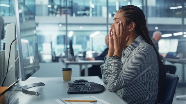 Black Female Corporate Office Worker Feels Stress, Frustration Works on Desktop Computer. Accountant Feeling Project Pressure, Massages Her Head, Works with Statistics, Has Bad Day. Stock Market Crash