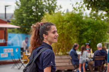 Naklejka premium A young Caucasian female walking in an amusement park