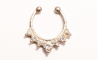 A set of jewelry for piercing on a white background. A set of earrings for the body, nose, navel, tongue, nipples, ears, various beauty jewelry, a set of cosmetological jewelry for piercing.