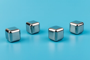 stainless steel ice cubes whiskey stones on blue background