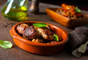 Plate soba with fried cutlets and sauce on a table.