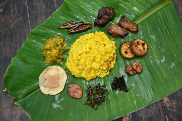 Fresh bengali dish khichudi and all all vegetable fry served on fresh green banana leaves. Hindu...