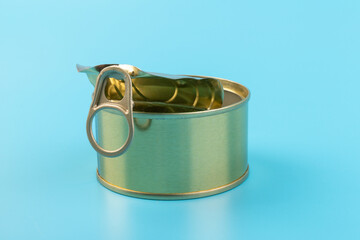 opened clean tin can with pull tab ring, bended lid and empty - isolated on blue