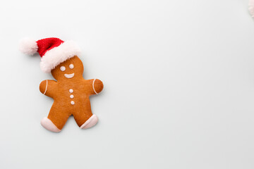 Gingerbread man, cookies and Christmas decor on pastel background.