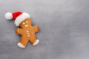 Gingerbread man, cookies and Christmas decor on pastel background.