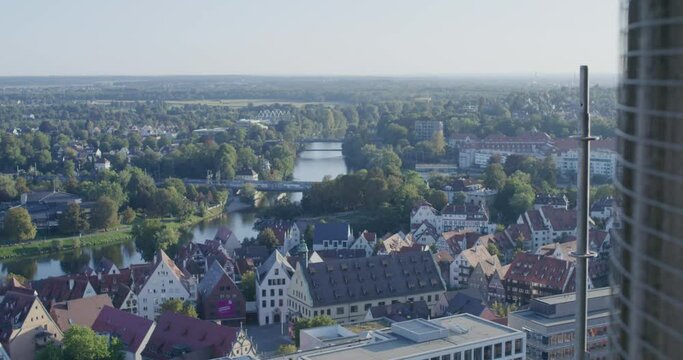 Camera tracking forward revealing the old town of Ulm, Danube and New-Ulm in the background. Shot from the famous Ulmer M&uuml;nster on a sunny summer day.