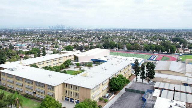 Crenshaw High school, bad area of Los Angeles, South Central community, overlooking city, rising aerial