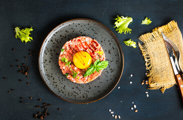 tar-tar from beef with raw yolk on plate