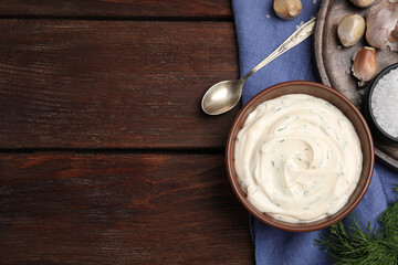 Tasty creamy dill sauce and ingredients on wooden table, flat lay. Space for text
