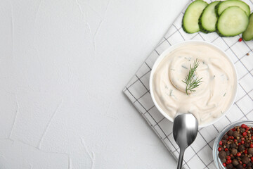 Tasty creamy dill sauce and ingredients on white table, flat lay. Space for text