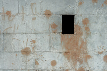 A white structured brick wall with color splashes