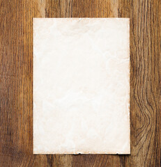 Vintage parchment paper on an antique wood background