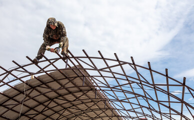 Workers are installing a metal canopy.