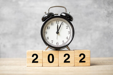 2022 text with clock on table. Resolution, time, plan, goal, motivation, reboot, countdown and New Year holiday concepts