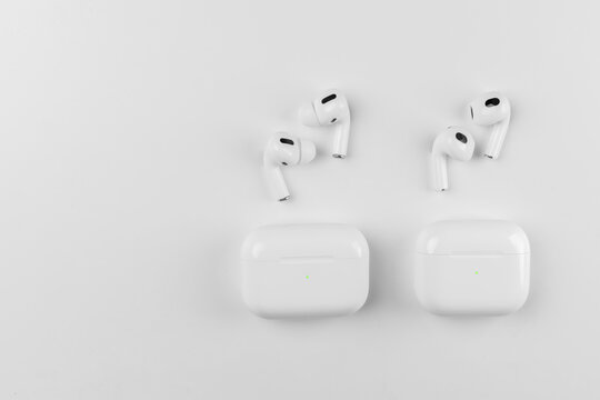 white wireless headphones on background