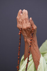 Close up of senior women hand praying at ramadan 