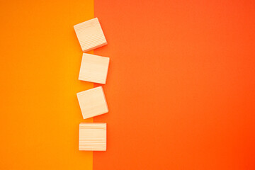 Blank four wooden cubes on colorful background with space for text